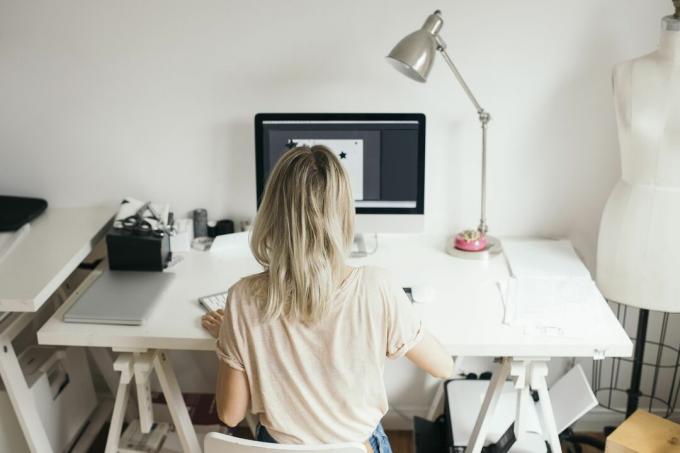 Vrouwelijke ontwerpprofessional die thuis computer gebruikt