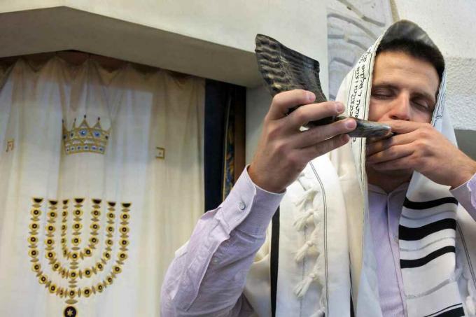 Joodse rabbi blaast sjofar in een synagoge