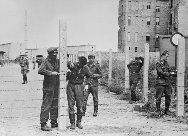 Soldaten die prikkeldraadhekken plaatsen ter voorbereiding van de Berlijnse muur, 14 augustus 1961.