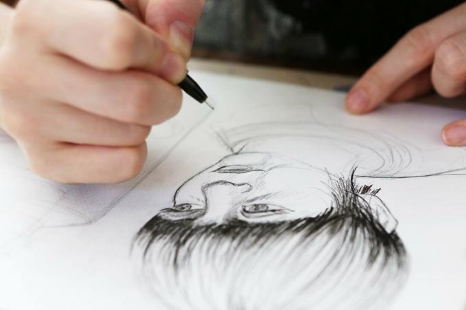 Een illustrator die aan een tekening werkt